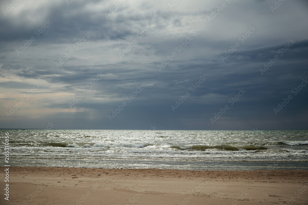 Dramatic beach with dark clouds before a storm. 