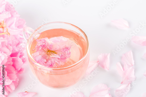 Sakura tea. Closeup of cherry blossom herb tea on white