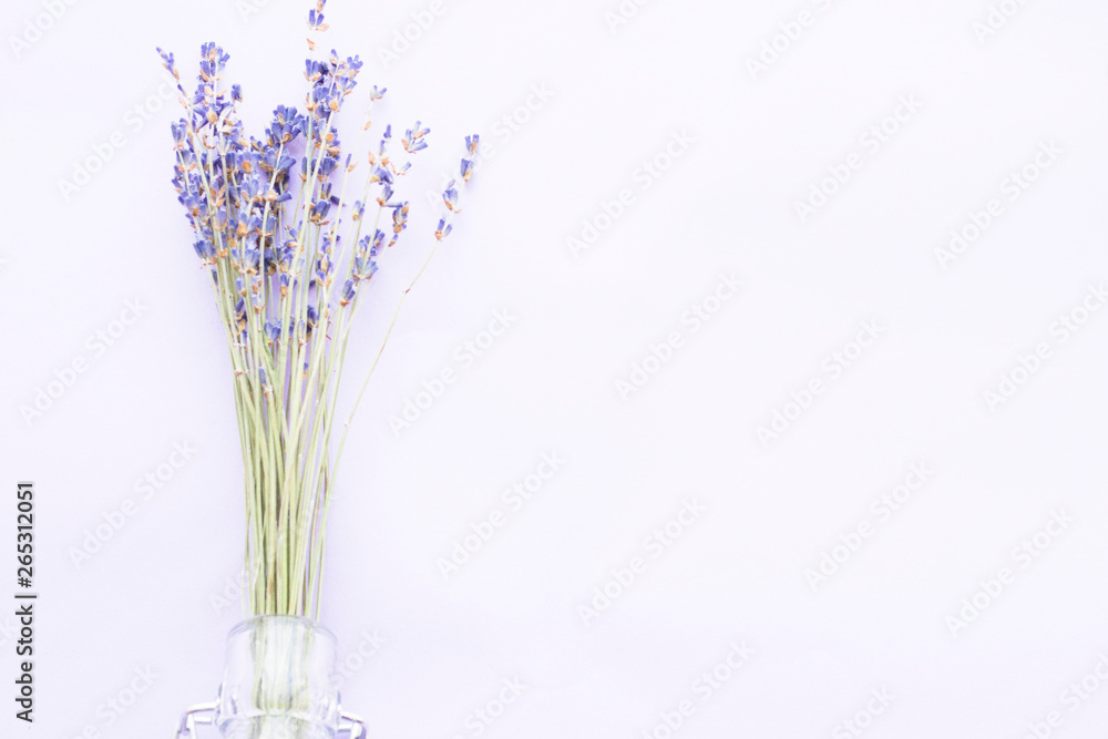 Naklejka premium Spa and wellness setting with lavender flowers, sea salt, oil in a bottle, aroma candle on wooden white background