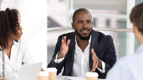 African american businessman coach negotiator speaking at diverse team meeting