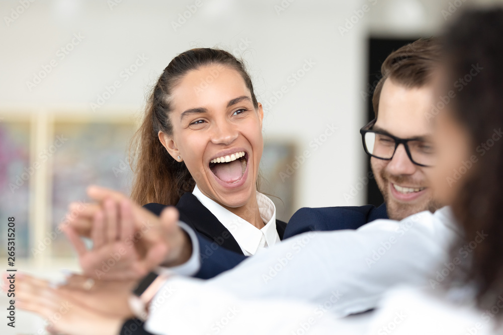 Happy businesswoman team member stack hands in pile celebrating success Happy businesswoman team member stack hands in pile celebrating success