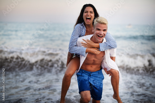Happy young couple having fun and love on the beach
