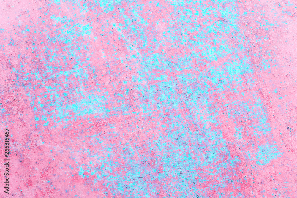 Old rusted metal sheet with peeling off pink and blue textured paint background with copy space