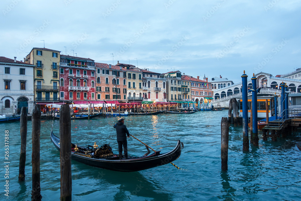 VENICE, ITALY- December 21, 2017 : Tourists on water street with Gondola in Venice,ITALY
