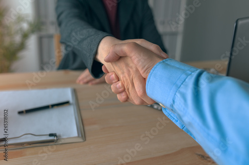 Businessman and businesswoman handshake