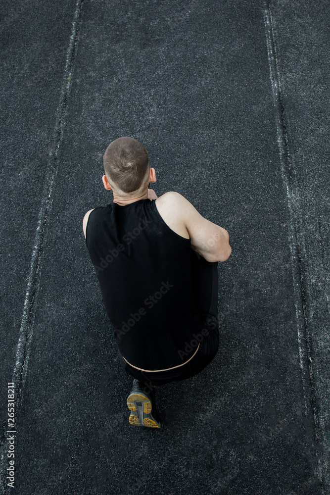 Caucasian man preparing for the start of the sprint. stadium, rubber track. athletics competitions. Track and field runner in sport uniform. athlete, top view