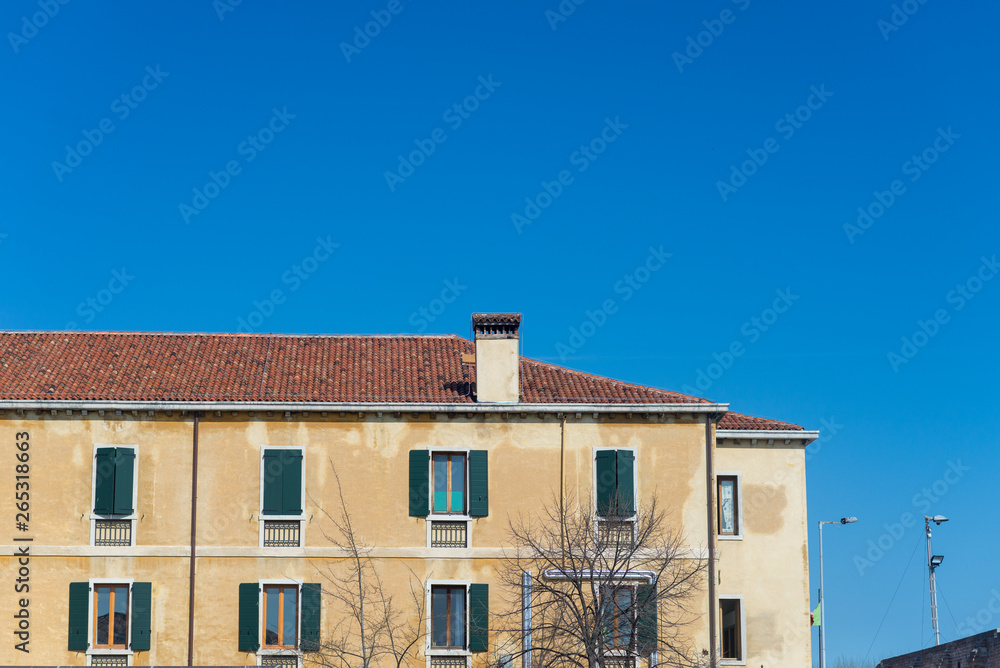 Gondola passing by multicolored buildings