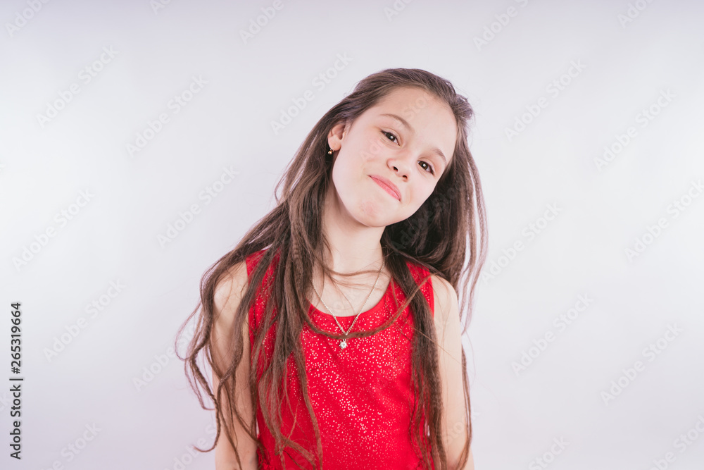 Child model on a white background. Little girl with long hair standing on white background Child model on a white background. Little girl with long hair standing on white background