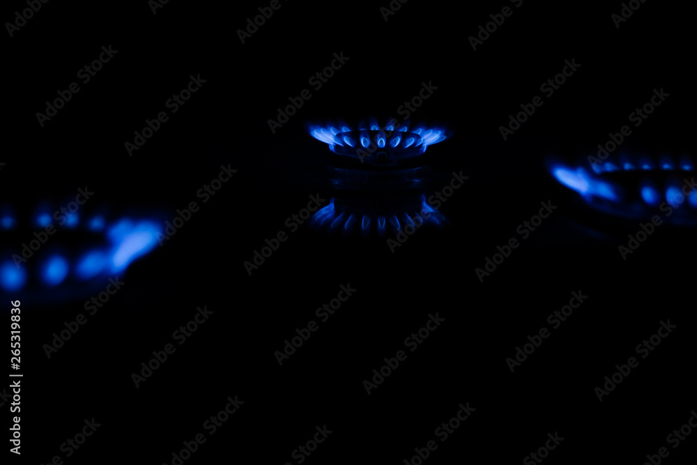 Blue flame of a gas stove in the dark. gas-burner