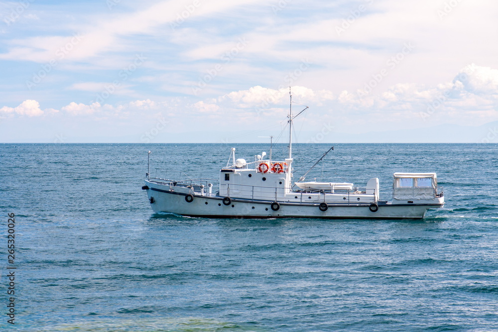 Fishing ship on the water surface in clear weather