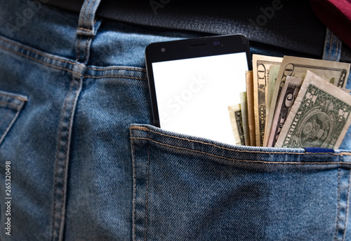 Money and phone stick from the back pocket of jeans