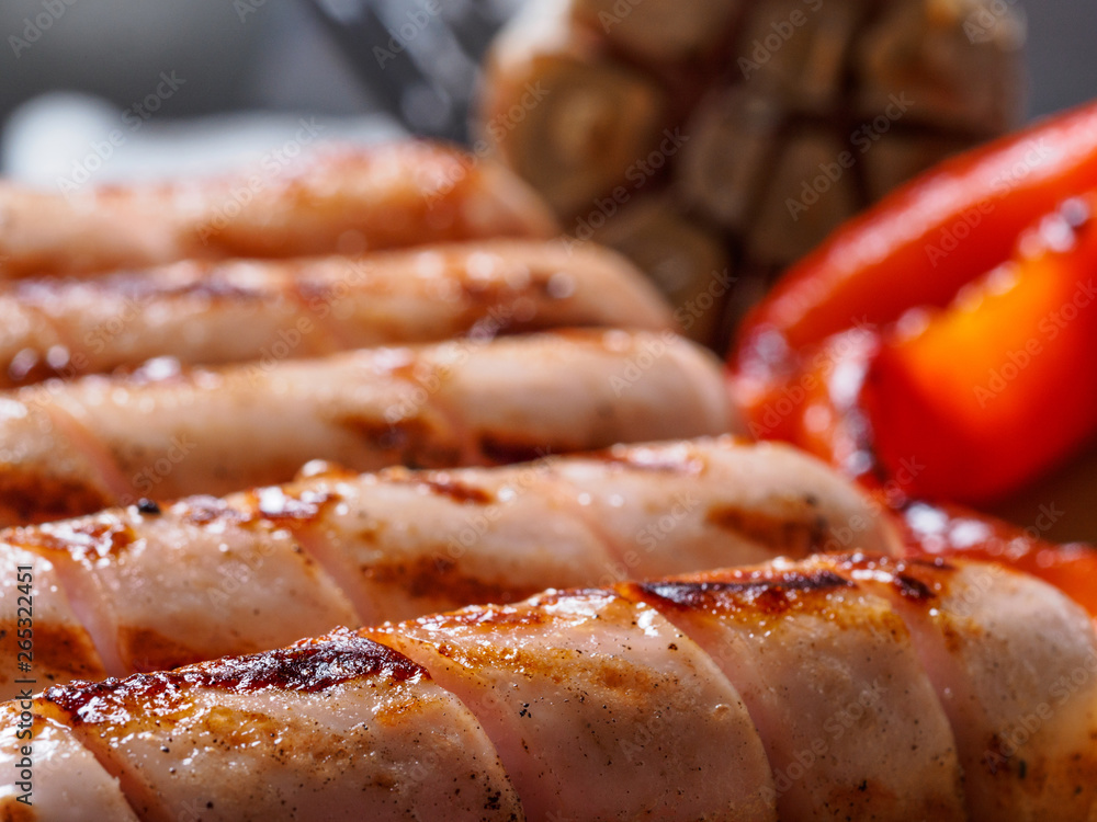 Close up view of chicken homemade sausages. Grilled sausages and grilled vegetables. Copy space. Close up view of chicken homemade sausages. Grilled sausages and grilled vegetables. Copy space.