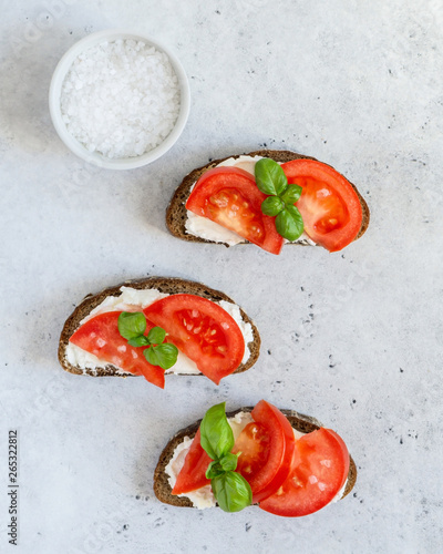 Toasted bread with tomatoes, ricotta (cream cheese), basil