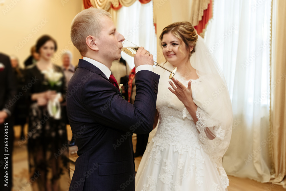 happy gorgeous bride and stylish groom drinking champagne, emotional moment, official ceremony happy gorgeous bride and stylish groom drinking champagne, emotional moment, official ceremony