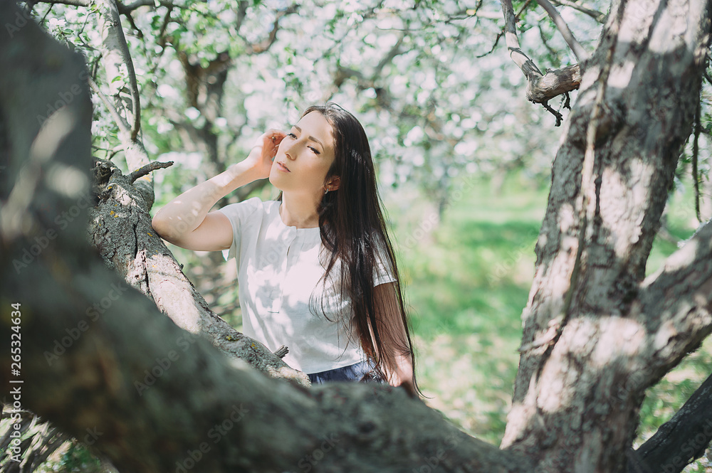 Beautiful girl posing in the blooming garden. apple, cherry Beautiful girl posing in the blooming garden. apple, cherry