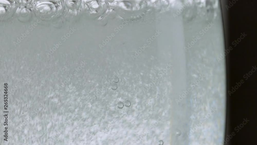 Pouring soda water into a clear glass. Pouring soda water into a clear glass.