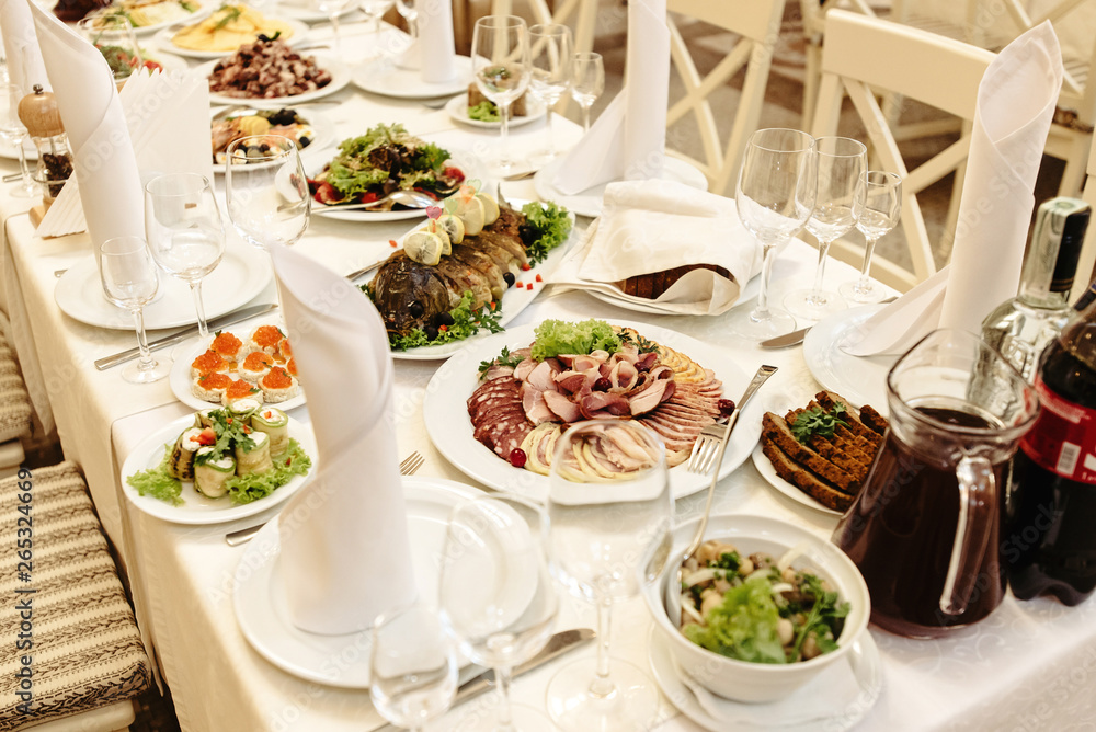 stylish fashionable decorated table with flowers and delicious food, celebration wedding, catering in the restaurant stylish fashionable decorated table with flowers and delicious food, celebration wedding, catering in the restaurant