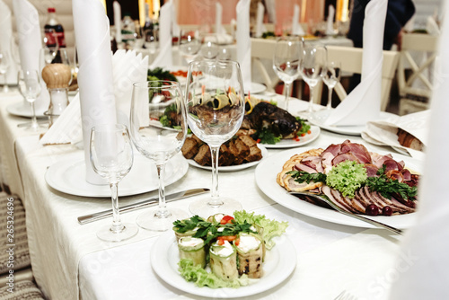 stylish fashionable decorated table with glasses and delicious food  celebration wedding  catering in the restaurant