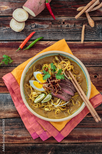 Bowl of spicy mee rebus with chopsticks, malaysian cuisine