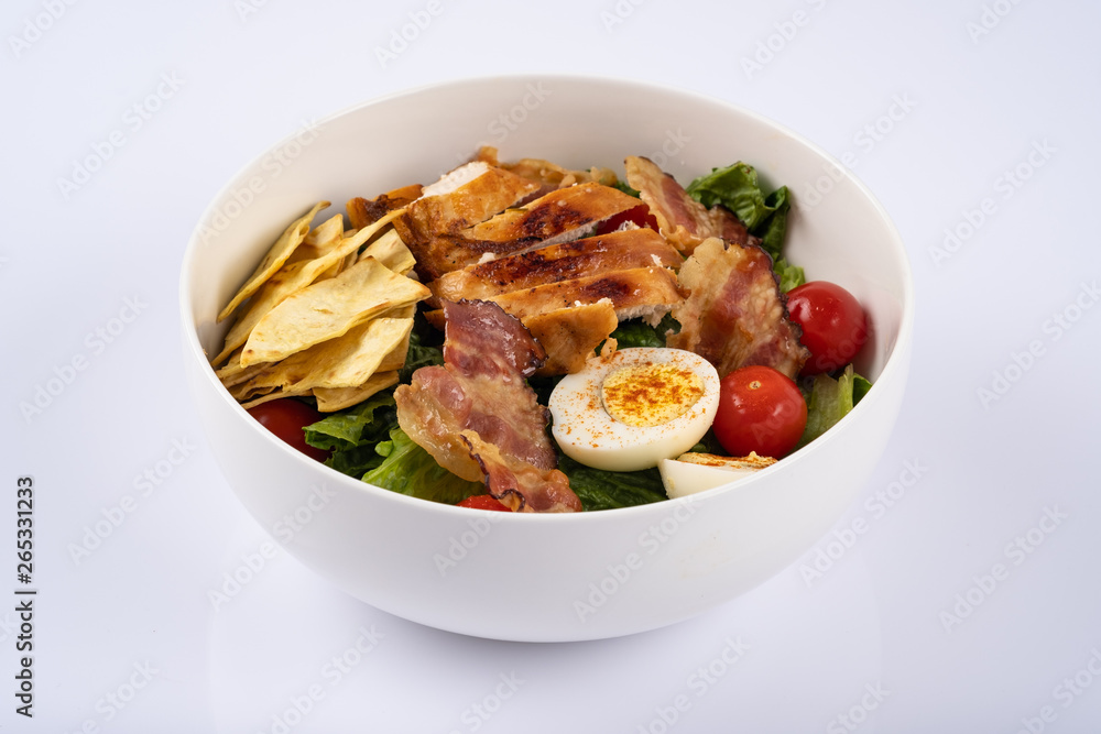 Homemade salat with chiken, eggs, cherry and bacon Homemade salat with chiken, eggs, cherry and bacon