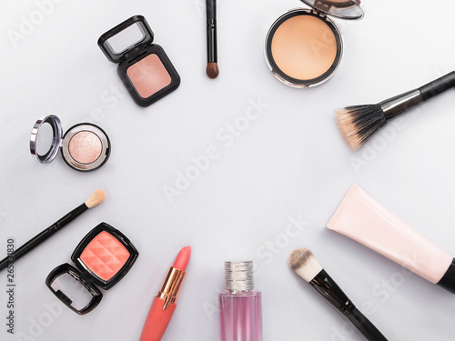 Lipstick, tools, eyeliner, blush, perfume, eye shadow and powder cosmetic in blue theme make up on frame for promotion. Set of decorative cosmetics. Copy space.