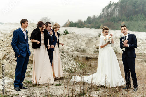 Wallpaper Mural bride and groom with happy groomsmen and bridesmaids having fun and laughing and popping champagne, luxury wedding celebration Torontodigital.ca