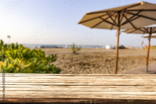 Table background of free space for your decoration and morning blurred background of beach and sea  © magdal3na