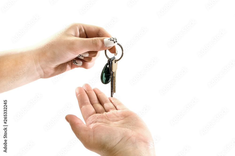 hand gives keys to hand on white background hand gives keys to hand on white background