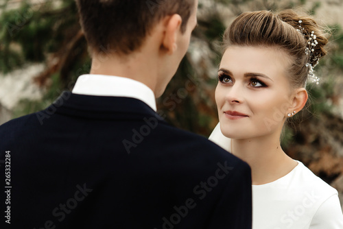happy bride looking at her groom at sandy lake, luxury elegant wedding © sonyachny