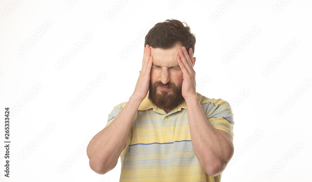 Feeling terrible headache. Portrait of bearded man is standing and touching his temples while suffering from pain. Feeling terrible headache. Portrait of bearded man is standing and touching his temples while suffering from pain.