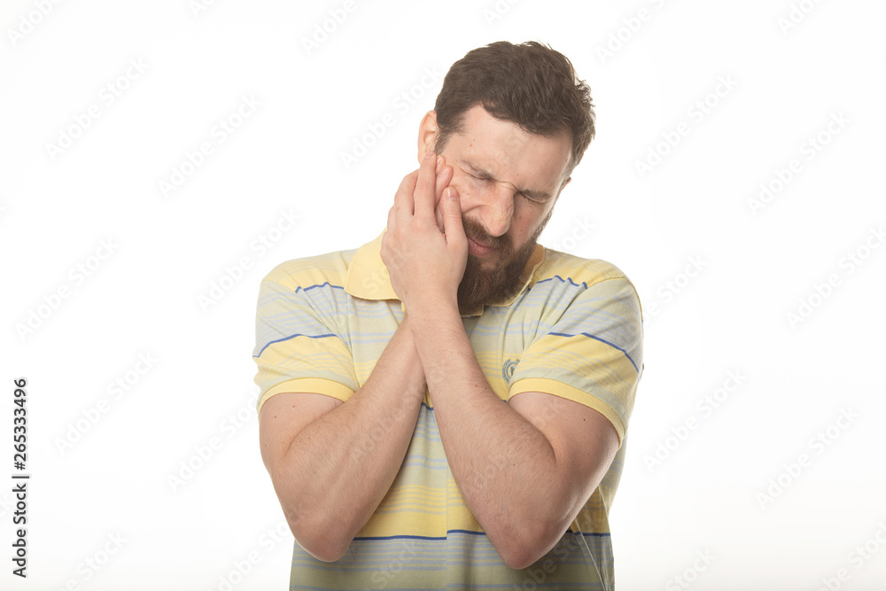 Depressed ill man having toothache and touching cheek Depressed ill man having toothache and touching cheek