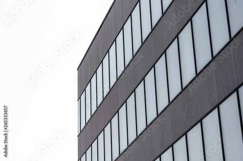 many empty windows of a gray concrete building