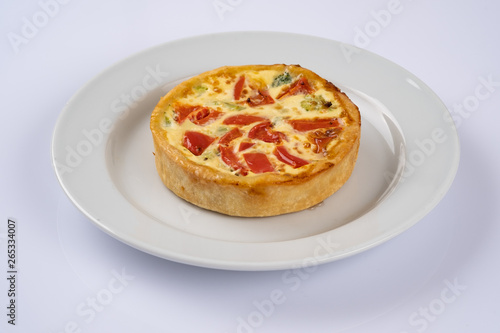 Broccoli cheddar mini savory pies on white plate. Delicious appetizers, snack, tapas. Flat lay.