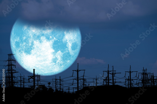 blue milk moon back on silhouette electric pole on night sky