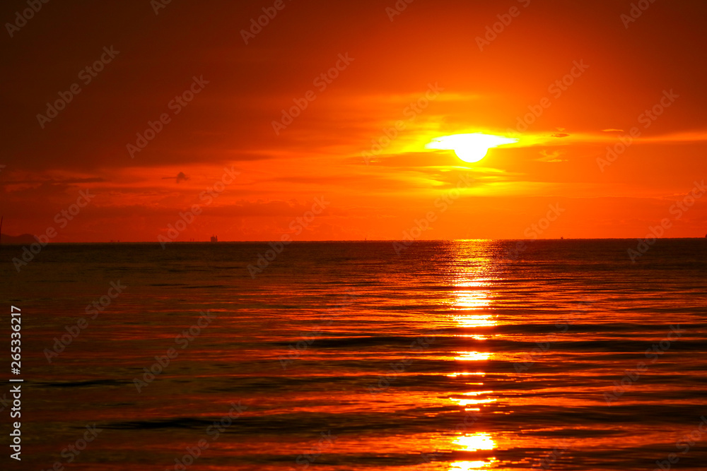 Fototapeta premium sunset on sea and ocean last light red sky silhouette cloud