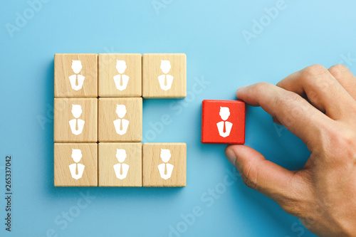 Building a good team, recruitment business and human resources concept, wooden blocks with people icon on table, blue background.