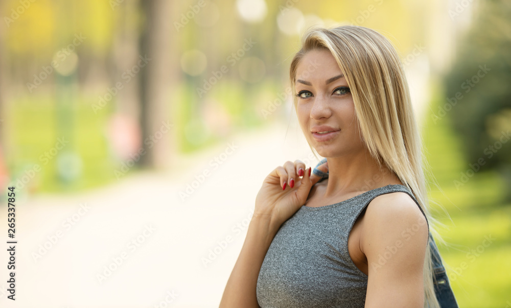 Beautiful smiling girl outdoor. A portrait of a beautiful blonde young Caucasian woman outdoor. Beautiful smiling girl outdoor. A portrait of a beautiful blonde young Caucasian woman outdoor.