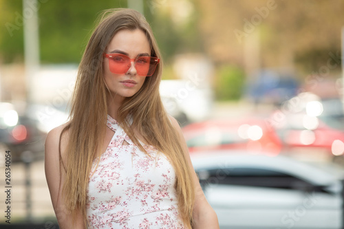 Close-up portrait of magnificent caucasian girl in round pink sunglasses.