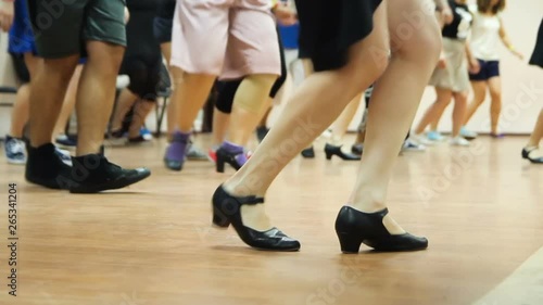 Dancing legs close-up. Dancers learning new moves. Woman teaching solo jazz swing dance.