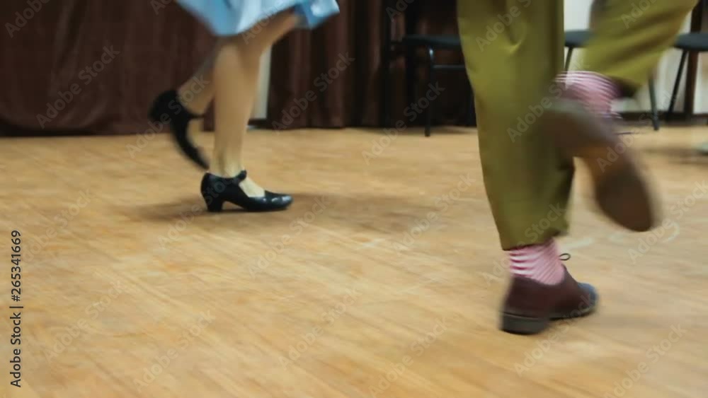 Dancing legs close up. Dancers perform lindy hop dance at the swing festival. Dancing legs close up. Dancers perform lindy hop dance at the swing festival.
