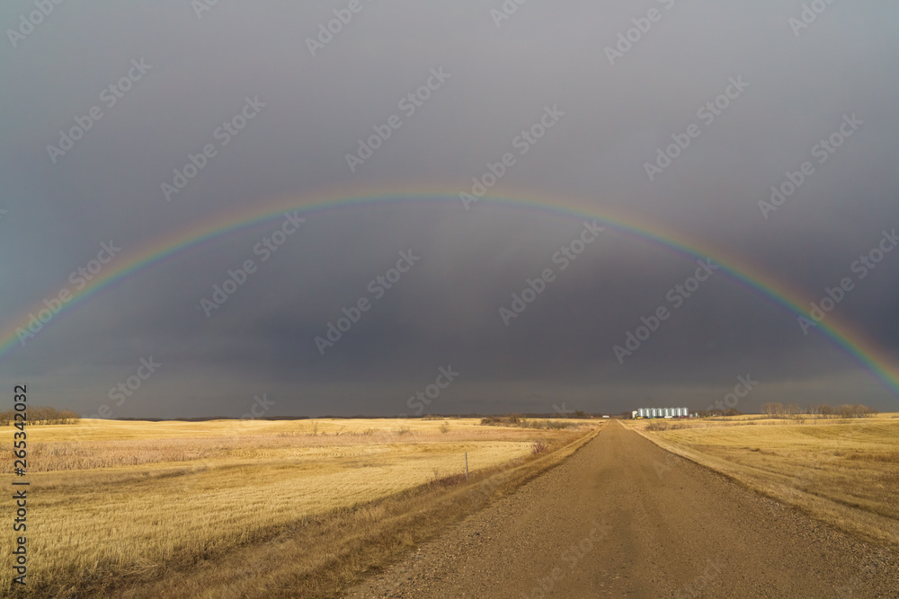 rainbow in a dark sky on the prairies rainbow in a dark sky on the prairies