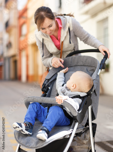  mother with son in a stroller walks