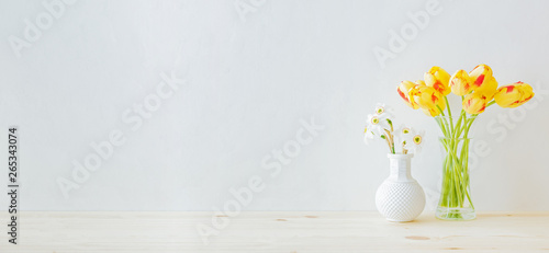 Wallpaper Mural Home interior with decor elements. Yellow tulips in a glass vase on a wooden table Torontodigital.ca