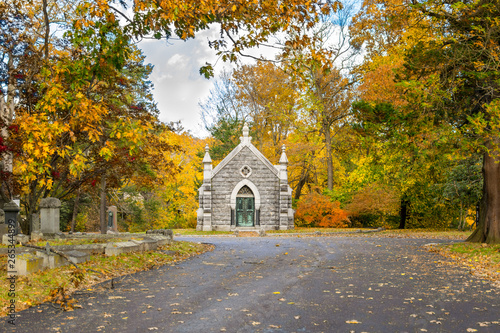 Fotografie Small mausoleum at Sleepy Hollow Cemetery, surrounded by autumnal fall foliage,