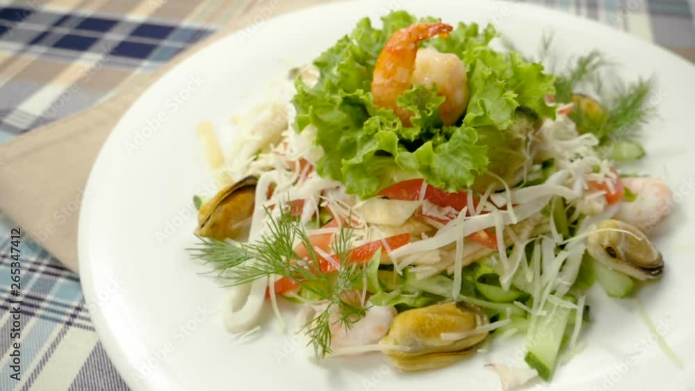 Healthy salad with mussels, shrimps, squid, lettuce, tomatoes, cucumber, apple, cheese. Slow motion. HD Healthy salad with mussels, shrimps, squid, lettuce, tomatoes, cucumber, apple, cheese. Slow motion. HD