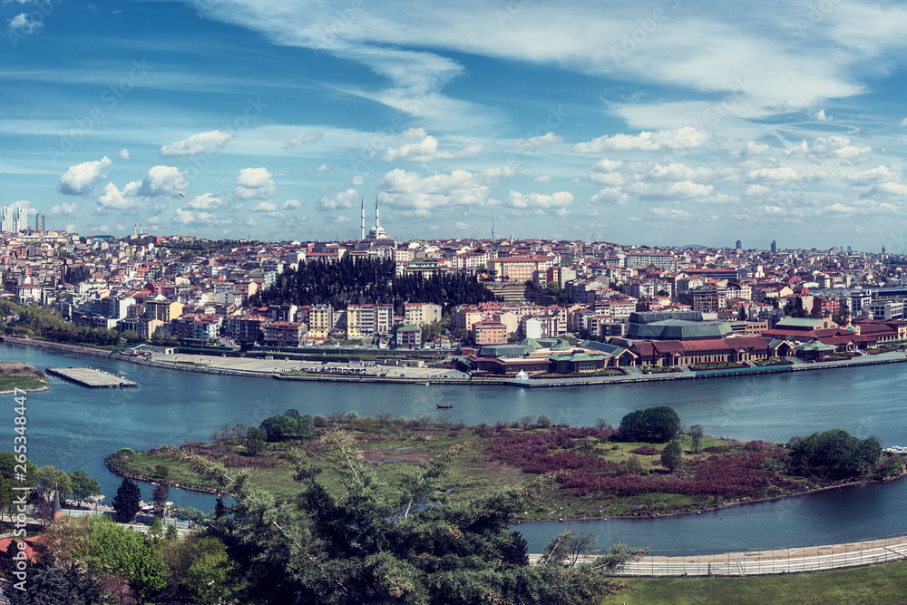 Fototapeta premium Panoramic view of Istanbul from Pierre Loti Hill (Tepesi). Beautiful day time cityscape with Golden Horn bay, buildings and blue sky with clouds, Turkey. Travel background for wallpaper or guide book