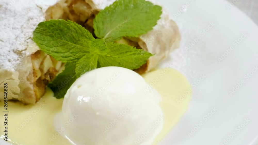 Close-up shot of strudel with apples, ice cream and mint. Slow motion. HD Close-up shot of strudel with apples, ice cream and mint. Slow motion. HD