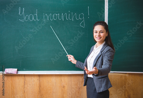 a young teacher explains near the board