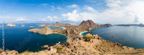 Tourists observing the Panoramic view from the top of Padar Island in Komodo National park in autumn, a protected area which is a paradise for diving, Lubuan Bajo, Flores, Nusa Tenggara, Indonesia photo
