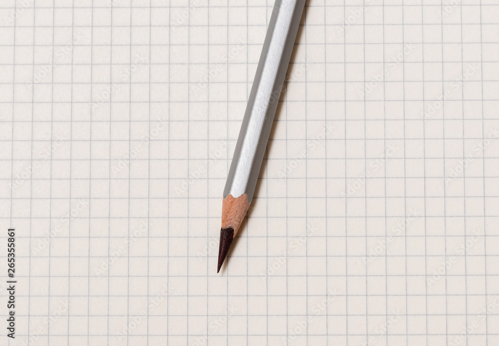 white checked notebook and gray pencil closeup white checked notebook and gray pencil closeup